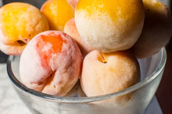 Frozen apricots in a bowl close-up