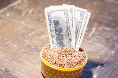 Karabuğdaylı bir kasede banknotlar. Savaş nedeniyle Ukrayna 'da gıda fiyatlarındaki artış