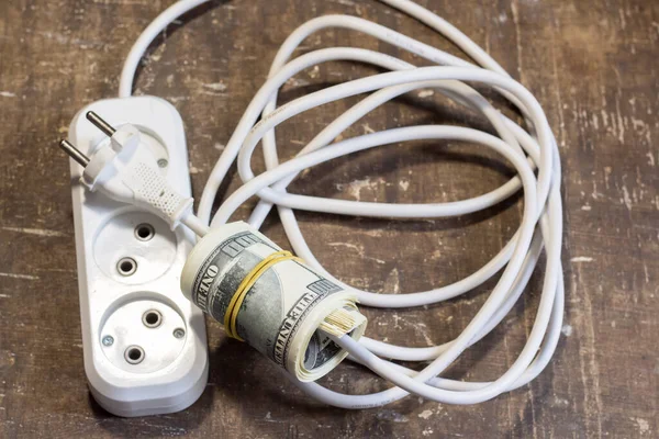 Money bills near the power cable