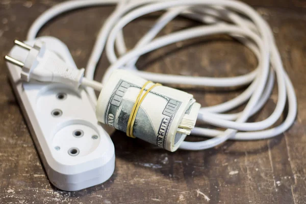 Money bills near the power cable