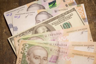 100 dollar bill among 500 hryvnia bills. Inflation in Ukraine due to the war