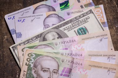 100 dollar bill among 500 hryvnia bills. Inflation in Ukraine due to the war
