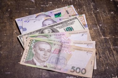 100 dollar bill among 500 hryvnia bills. Inflation in Ukraine due to the war