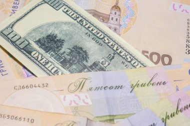 100 dollar bill among 500 hryvnia bills. Inflation in Ukraine due to the war