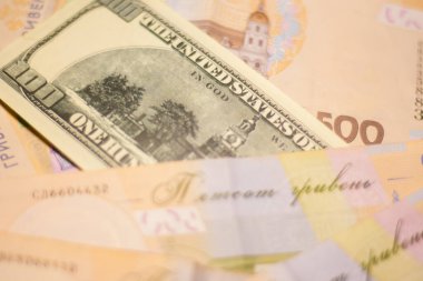 100 dollar bill among 500 hryvnia bills. Inflation in Ukraine due to the war