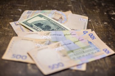 100 dollar bill among 500 hryvnia bills. Inflation in Ukraine due to the war