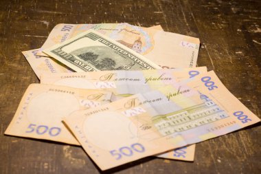 100 dollar bill among 500 hryvnia bills. Inflation in Ukraine due to the war