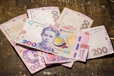 5 dollar coin among 200 hryvnia bills. Inflation in Ukraine due to the war