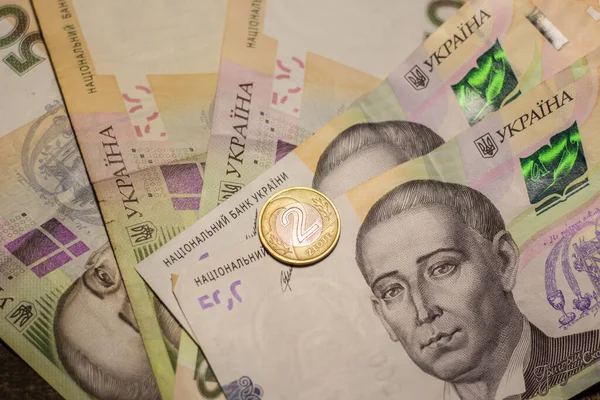 2 zloty coins among 500 hryvnia banknotes. Inflation in Ukraine due to the war