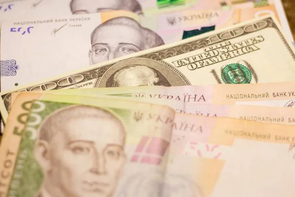 100 dollar bill among 500 hryvnia bills. Inflation in Ukraine due to the war