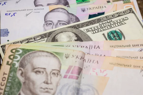 100 dollar bill among 500 hryvnia bills. Inflation in Ukraine due to the war