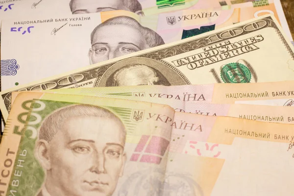 100 dollar bill among 500 hryvnia bills. Inflation in Ukraine due to the war
