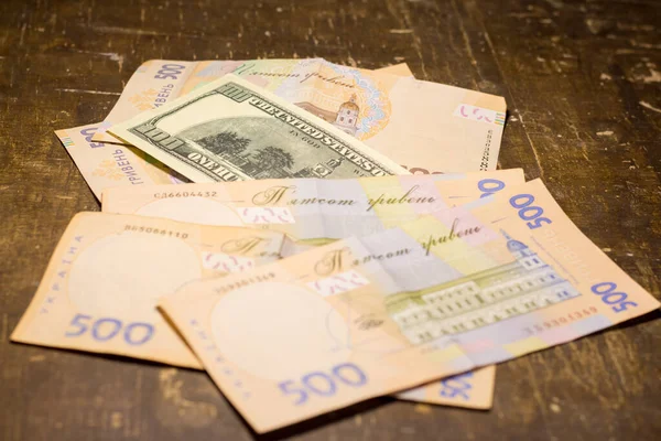 100 dollar bill among 500 hryvnia bills. Inflation in Ukraine due to the war