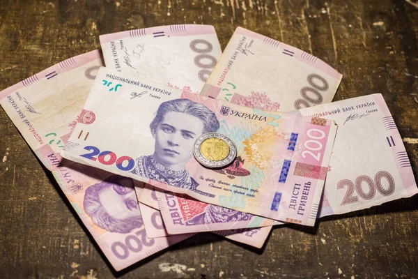 5 dollar coin among 200 hryvnia bills. Inflation in Ukraine due to the war