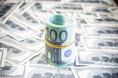 Euro bills on a roll on dollar bills. Inflation in Ukraine due to war