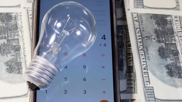 Light Bulb Lay Calculator Banknotes Saving Electricity Ukraine Due War — Vídeo de Stock