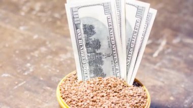 Karabuğdaylı bir kasede banknotlar. Savaş nedeniyle Ukrayna 'da gıda fiyatlarındaki artış