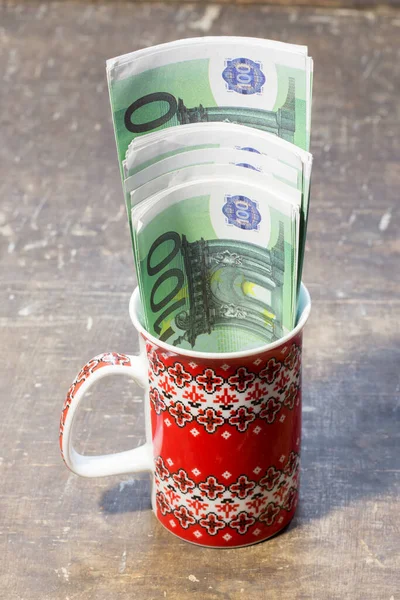Banknotes in a cup. The rise in prices for food and drinks in Ukraine due to the war