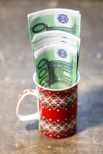 Banknotes in a cup. The rise in prices for food and drinks in Ukraine due to the war