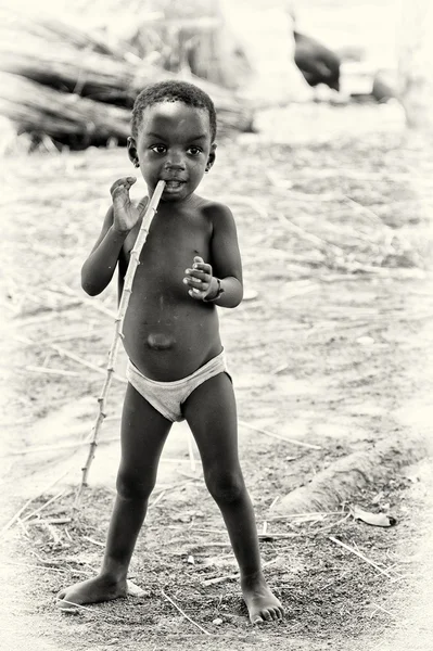 Ragazzino del Ghana con un bastone in bocca — Foto Stock