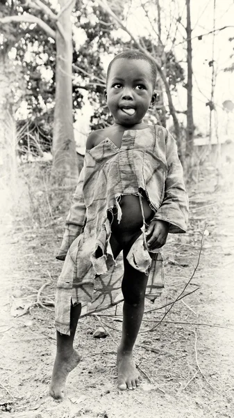 Little Ghanaian boy in a broken shirt — Stock Photo, Image