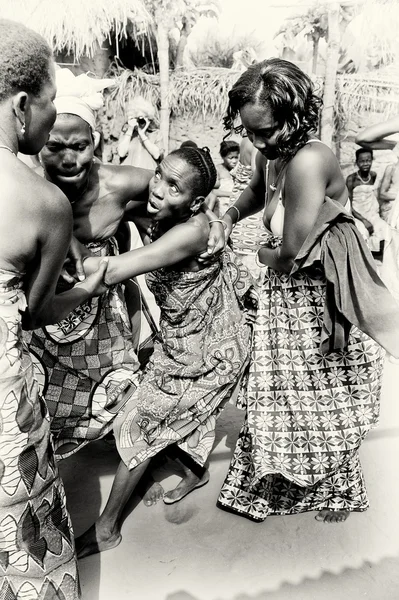 Duas senhoras do Togo ajudam seu amigo que perde o controle sob o encantamento do vodu — Fotografia de Stock