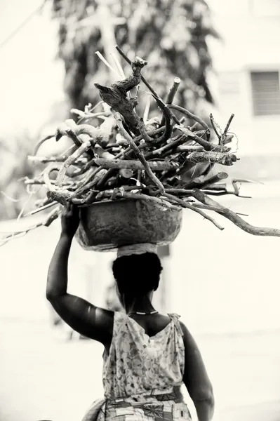 Une femme du Togo avec un tas de bois sur la tête — Photo