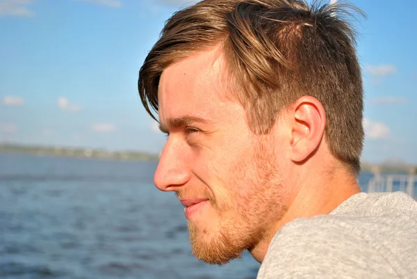 Beautiful portrait of a young man and water — Stock Photo, Image