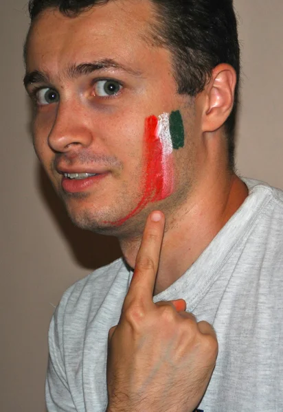 Young man with smashed Italian flag on cheek — Stock Photo, Image