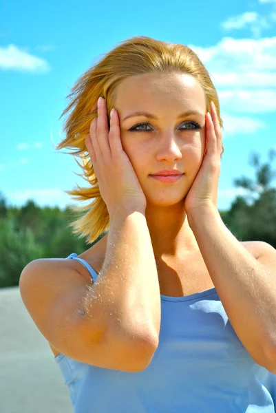 Beautiful girl touches her face — Stock Photo, Image