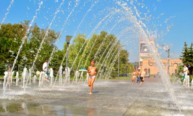 küçük çocuk bir sokak çeşme tatil sırasında çalış.