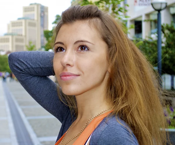 Portrait of a nice red hair girl on the city background — Stock Photo, Image