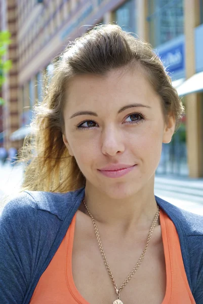 Portrait of a red-haired young girl in an orange shirt — Stock Photo, Image