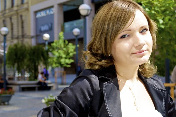 Beautiful shy girl poses in the city — Stock Photo, Image