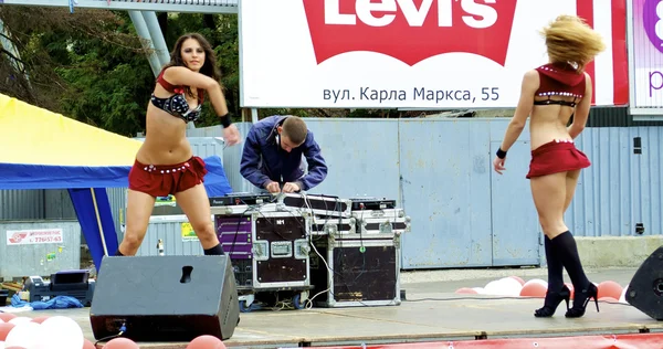 Sexual moves of two Russian sexy girls who dance in red clothes during the city holiday and promotion of new brand — Stock Photo, Image