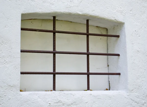 White window in grate — Stock Photo, Image