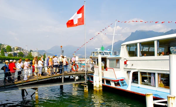 Happy tourists go on board of the Swiss ship — Stock Photo, Image