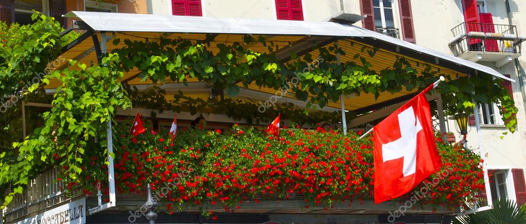 Balcony with roses and a Swiss flag