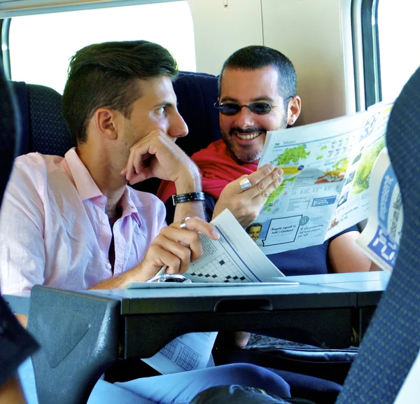 Passengers in train laugh and talk — Stock Photo, Image