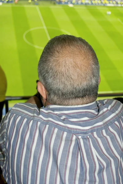 Bald supporter watches the game attentively — Stock Photo, Image