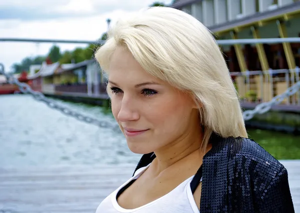 Portrait of a beautiful blond caucasian model girl in black jacket and jean — Stock Photo, Image