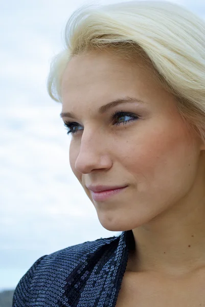 Face of a beautiful blond caucasian model girl in front of the sky Stock Image