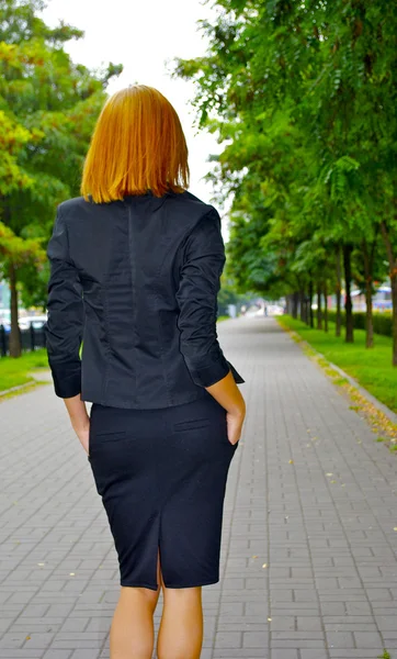 Sexual blond business girl on the alley — Stock Photo, Image