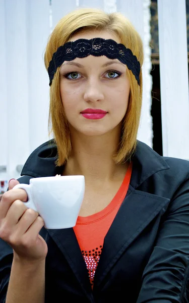Beautiful gangster girl with a cup of coffee — Stock Photo, Image