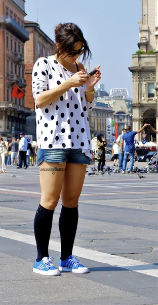 Girl with a tatoo checks her mails — Stock Photo, Image