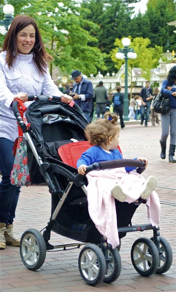 女性が乳母車で彼女の赤ん坊を運ぶ — ストック写真