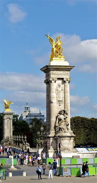 Column with a golden statue on the bridge of Alexandre III, Paris, France — Stock Photo, Image