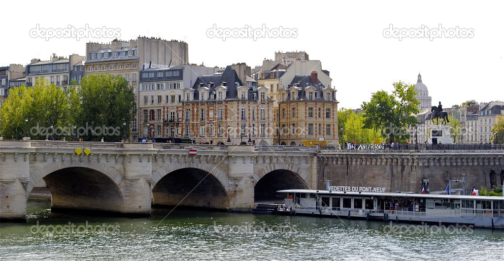 Tourist boat near the Pont Neuf. New bridge in Paris, France