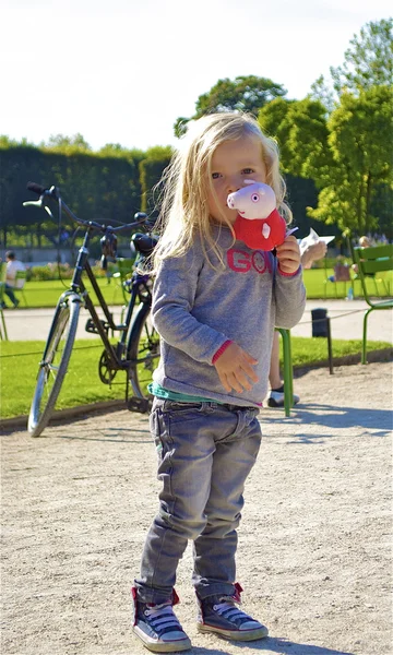 Little blond girl with a toy — Stock Photo, Image