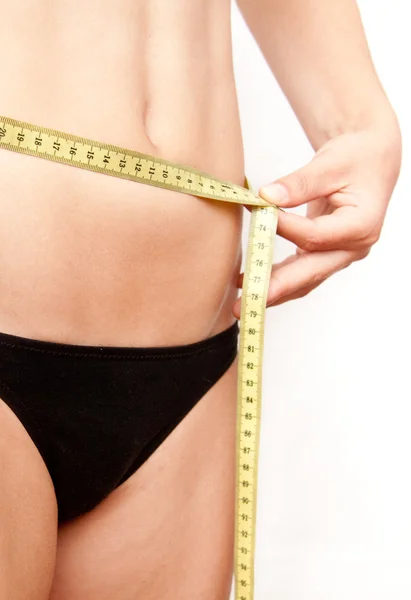 若い女性が彼女の胃を測定 — ストック写真